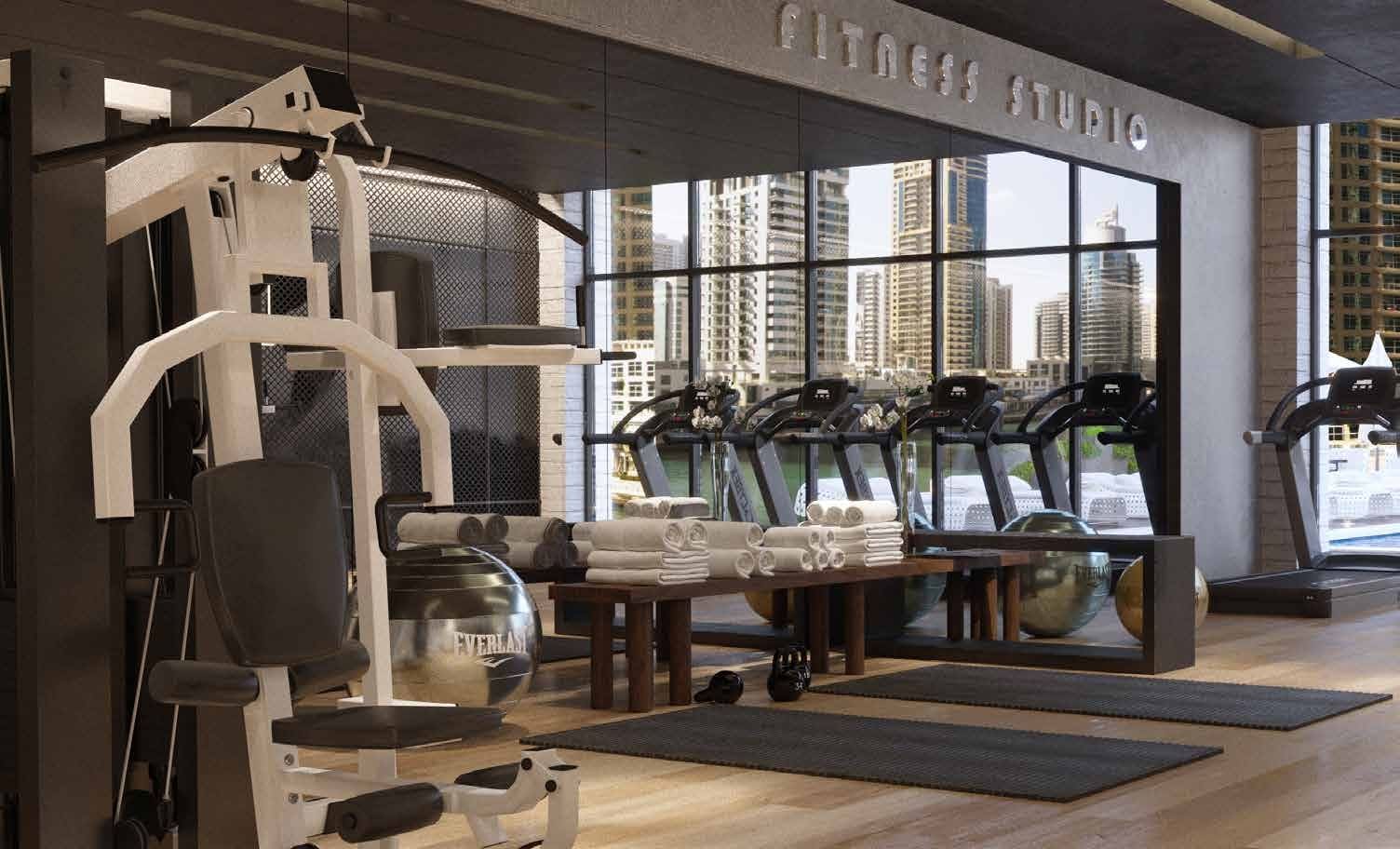 Luxurious gym overlooking the pool amenity image
