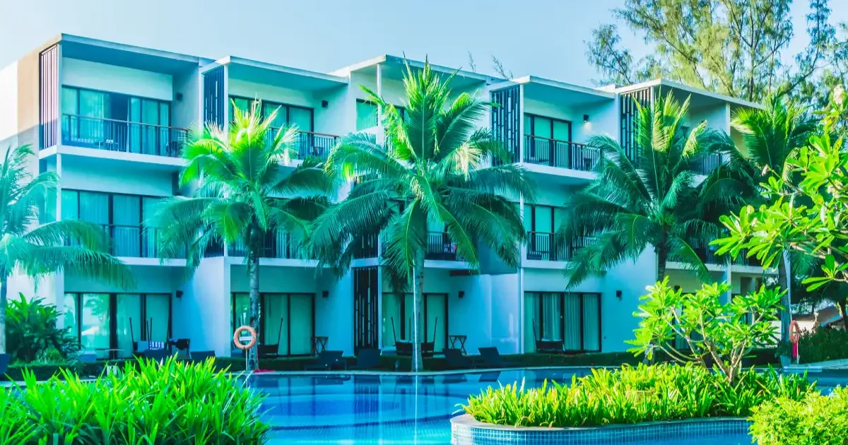 Luxury Dubai villa community with palm trees and modern poolside apartments